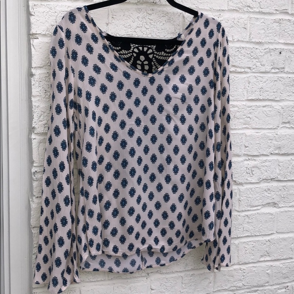 Patten blouse with back crochet detail.
